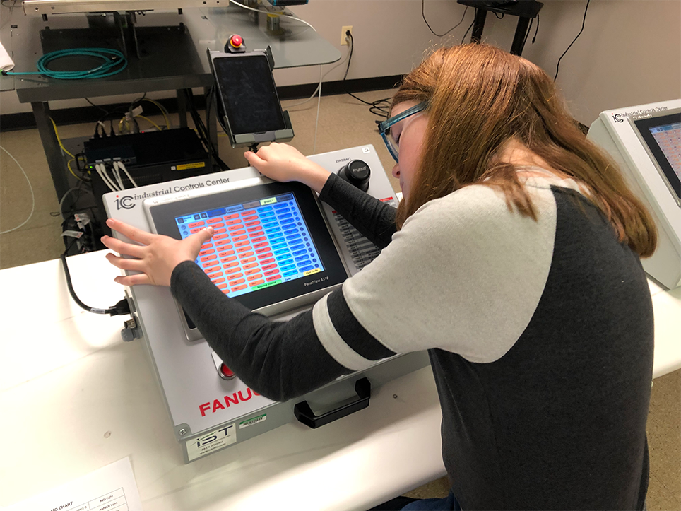 Middle school student using programmable logic controller