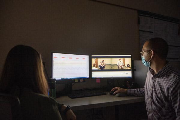 Gresham and Peters watch as Randall and Lang demonstrate how the Noldus Information Technology Observation suite works.