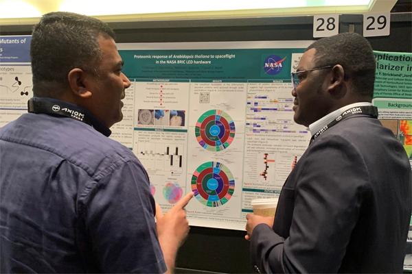 Gbolaga Olanrewaju discusses his poster at the conference.