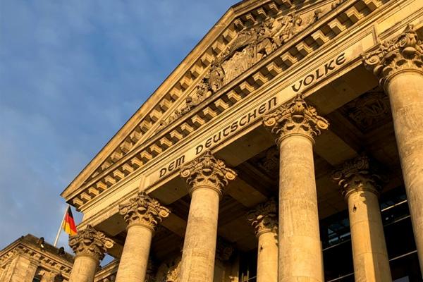 The Reichstag building was built in 1894 to house the German government. The inscription “Dem Deutschen Volke” (to the German people) was added in 1916, commissioned from the Jewish-owned Loevy foundry in the middle of World War I. The building was set on fire the year Hitler took power and and further damaged during World War II. Members of the Volke family either emigrated or were sent to concentration camps. Restoration of the building began after German reunification in 1990, and it has housed the lower