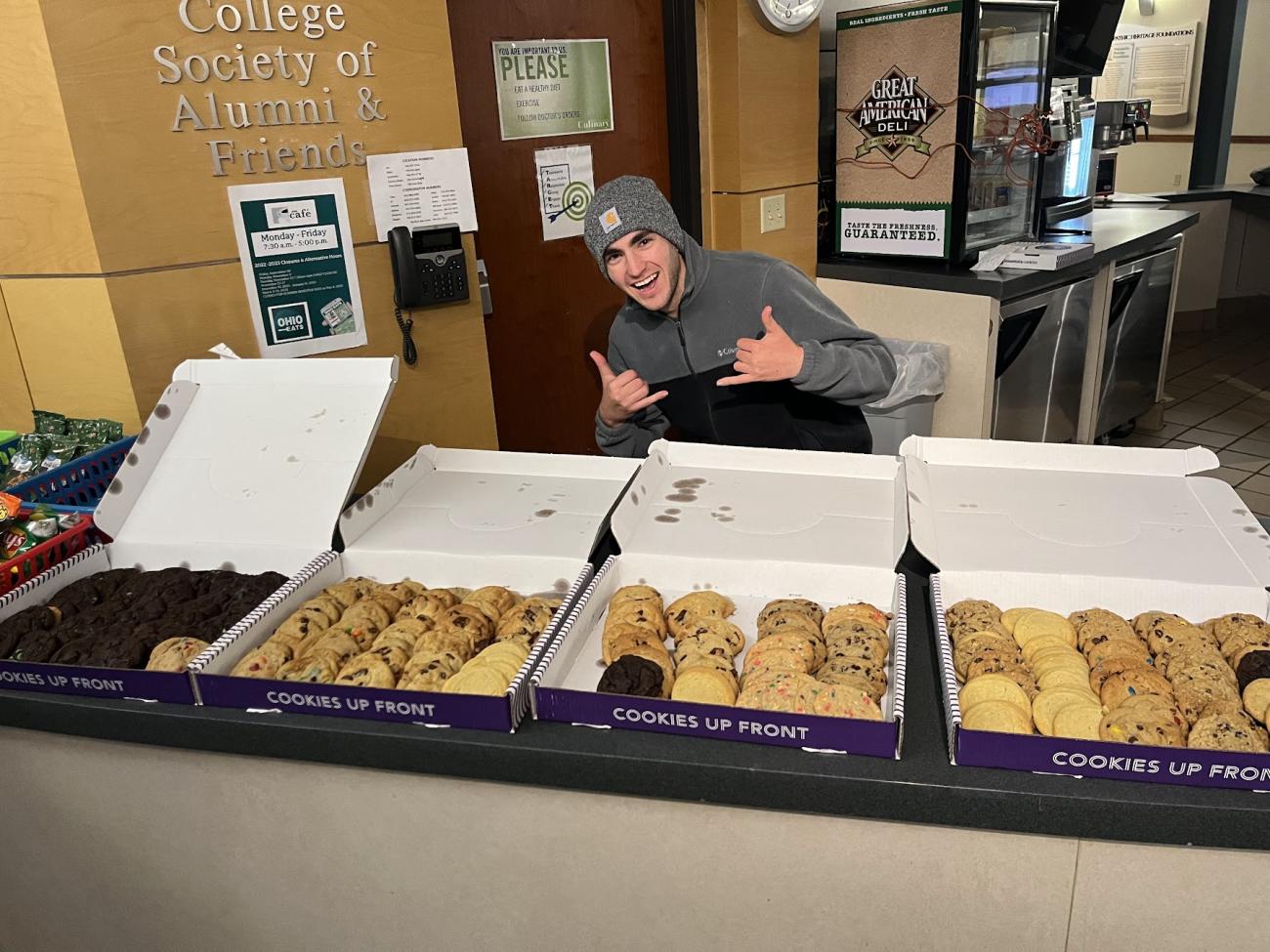 Student poses with snack bar at BlossomHack