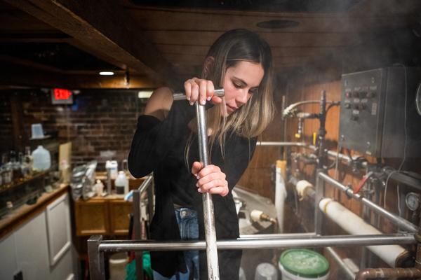 Francesca Carney stirs the mash at the Jackie O's Brewpub.