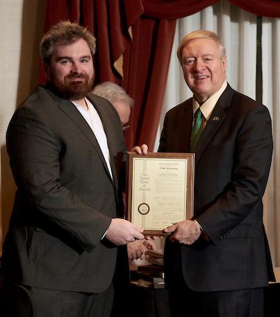 Duane Nellis and Chad Mourning holding award