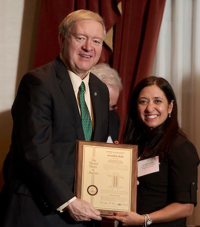 Duane Nellis and Gerardine Botte holding award