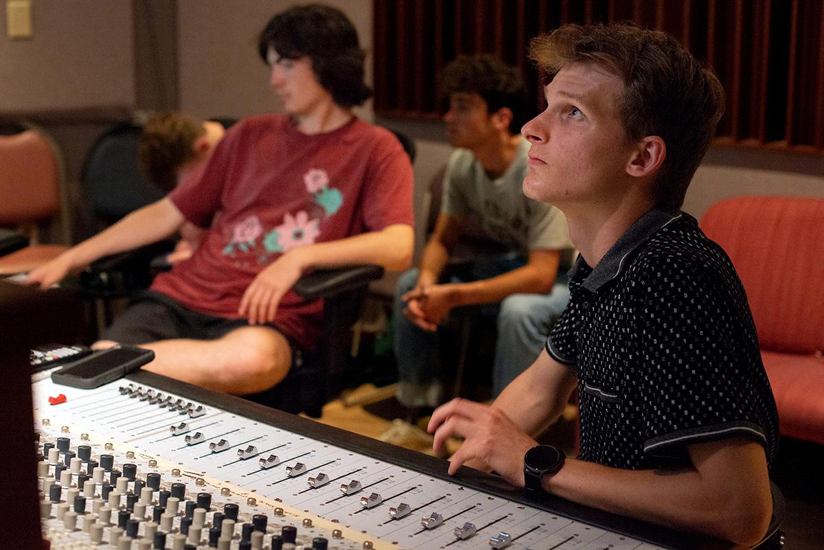 High school students use sound mixing equipment during the 2023 High School Media Workshop