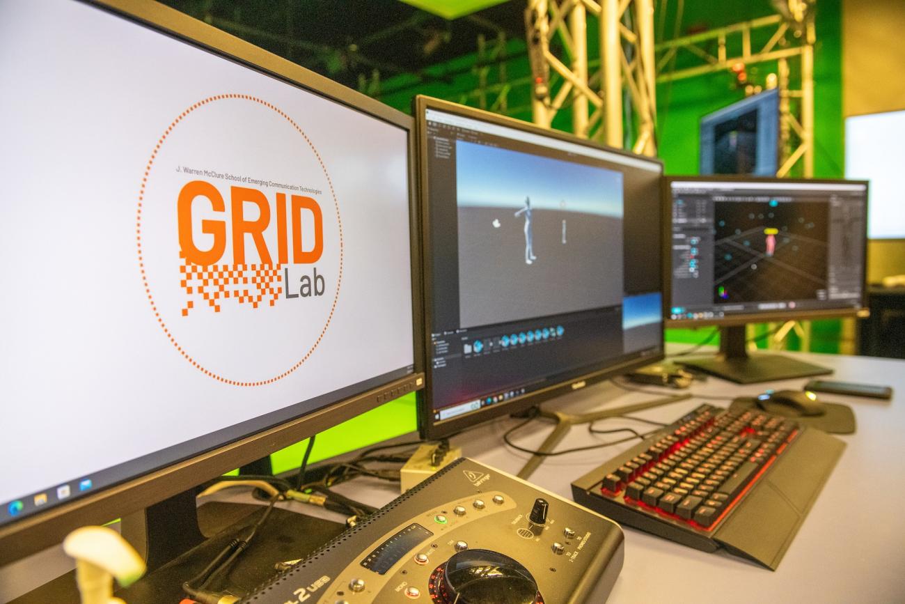 Computer screens are shown together in Ohio University's GRID Lab. One screen says GRID Lab.