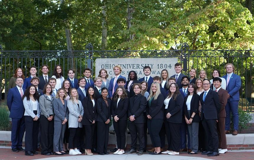 The members of the Emerging Leaders program are shown in front of the College Gate