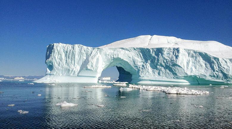 A glacier sits on the Arctic Sea in Greenland.