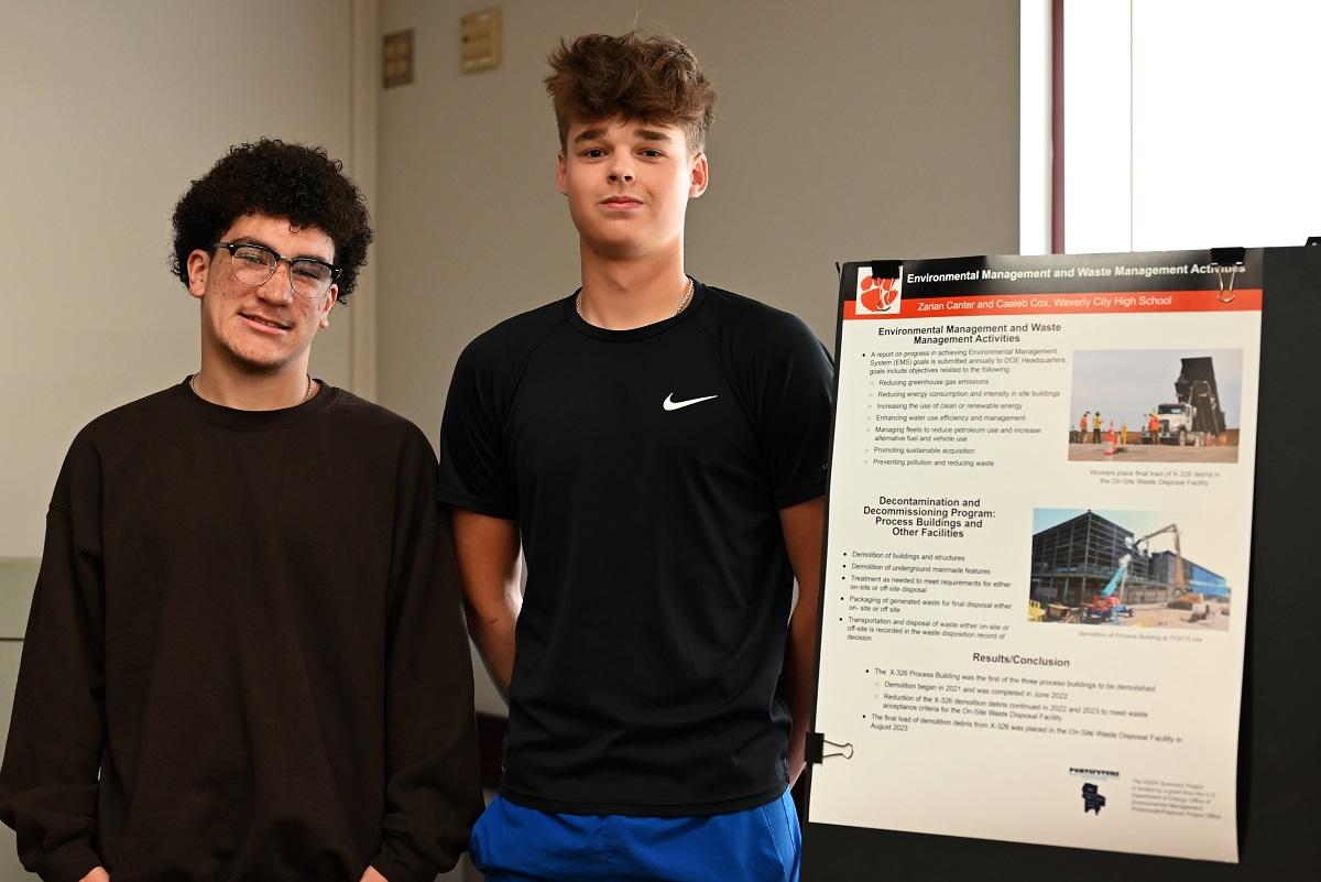 Two students stand by their project at the ASER Student Summary Project Student Expo 