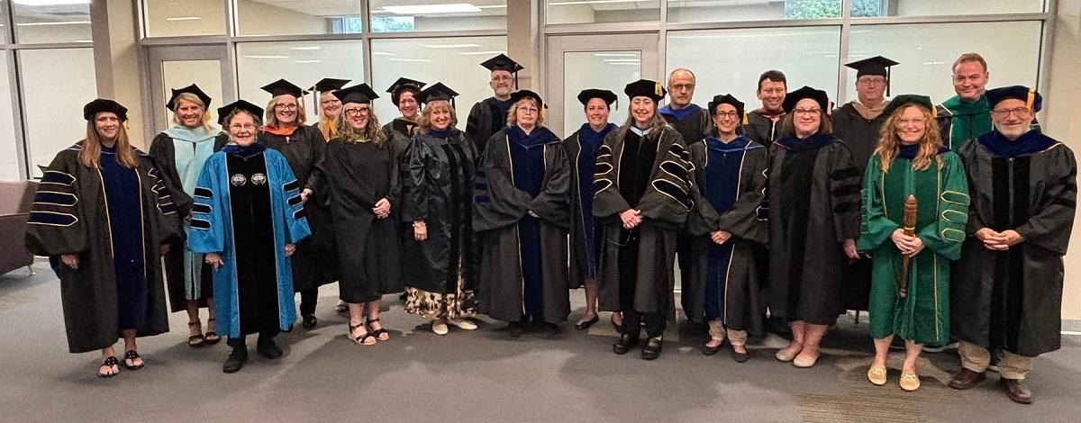 OHIO Lancaster Faculty and Staff wearing graduation regalia pose for a group photo at the Graduation Recognition Ceremony
