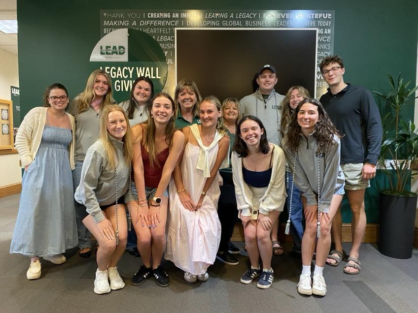 OHIO students, faculty and staff pose for a group photo in front of the Legacy Wall