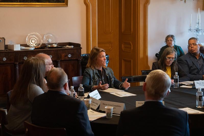 Mayors' Partnership for Progress members speak while sitting a table during a meeting