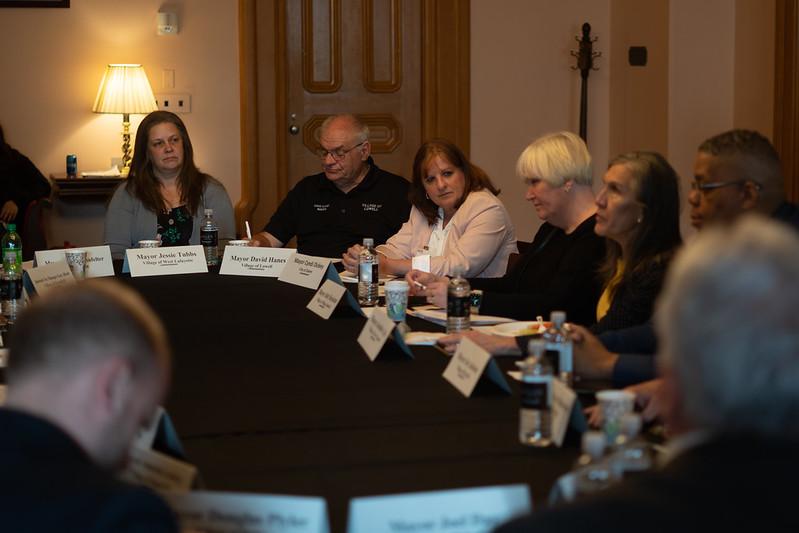 Mayors' Partnership for Progress members hold a meeting while seated around a table