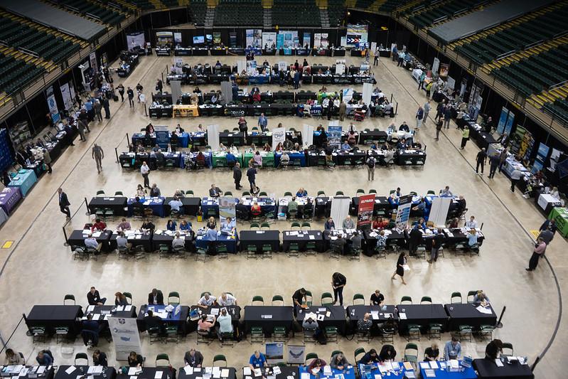 An image from above that shows row of booths filled with people talking at the Ohio Business Matchmaker event, held inside an arena in Dayton