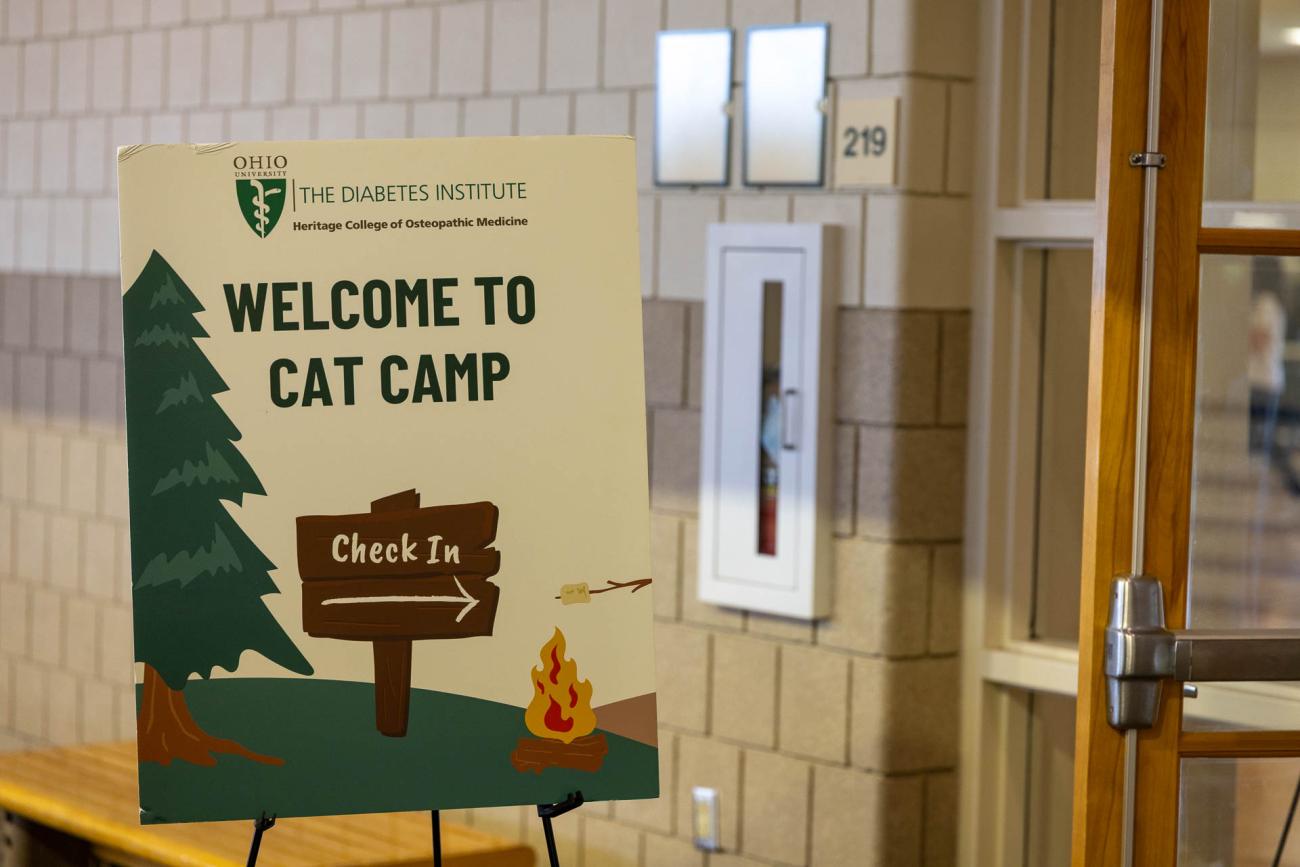 A sign welcomes participants to Cat Camp and points  to where they should check in