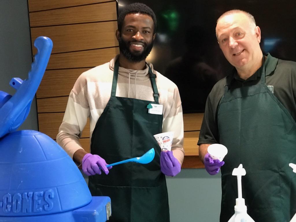 David Morkeh and another individual serve snow cones at OHIO Lancaster