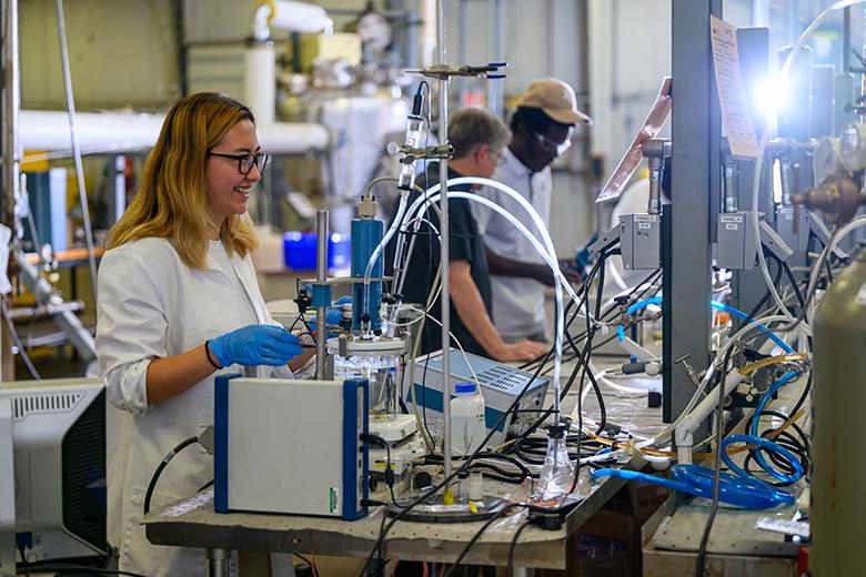 An ICMT student conducts research using bench-scale equipment.