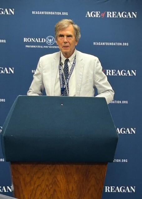 Chester Pach stands at a podium