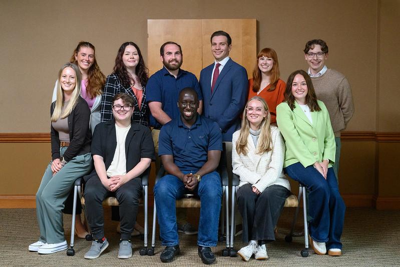 Students in the MPA program sit and stand together for a group photo