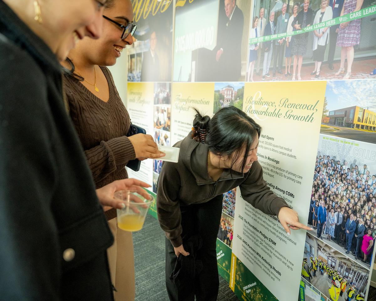 HCOM members looks at display board