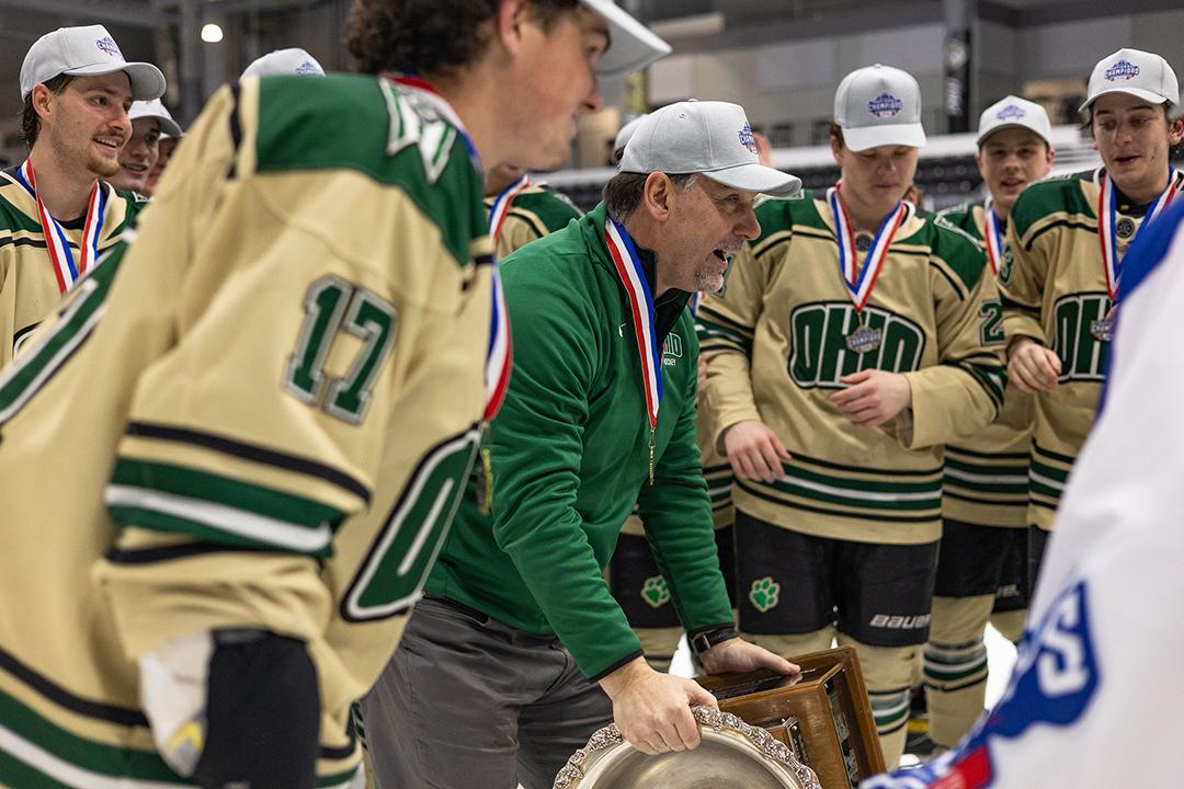 OHIO Hockey Head Coach Barry Schutte celebrates with the team moments before lifting the Murdoch Cup.