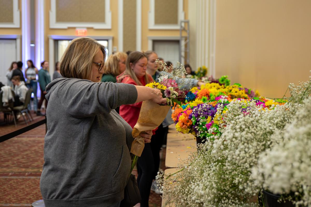 OHIO moms and students make flower bouquets from a long row of colorful flowers