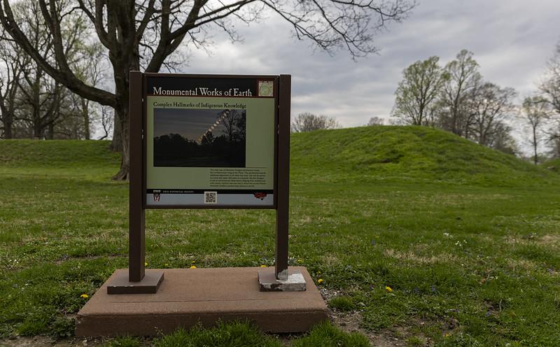 A sign says "Monumental Works of Earth" at the Hopewell Earthworks location