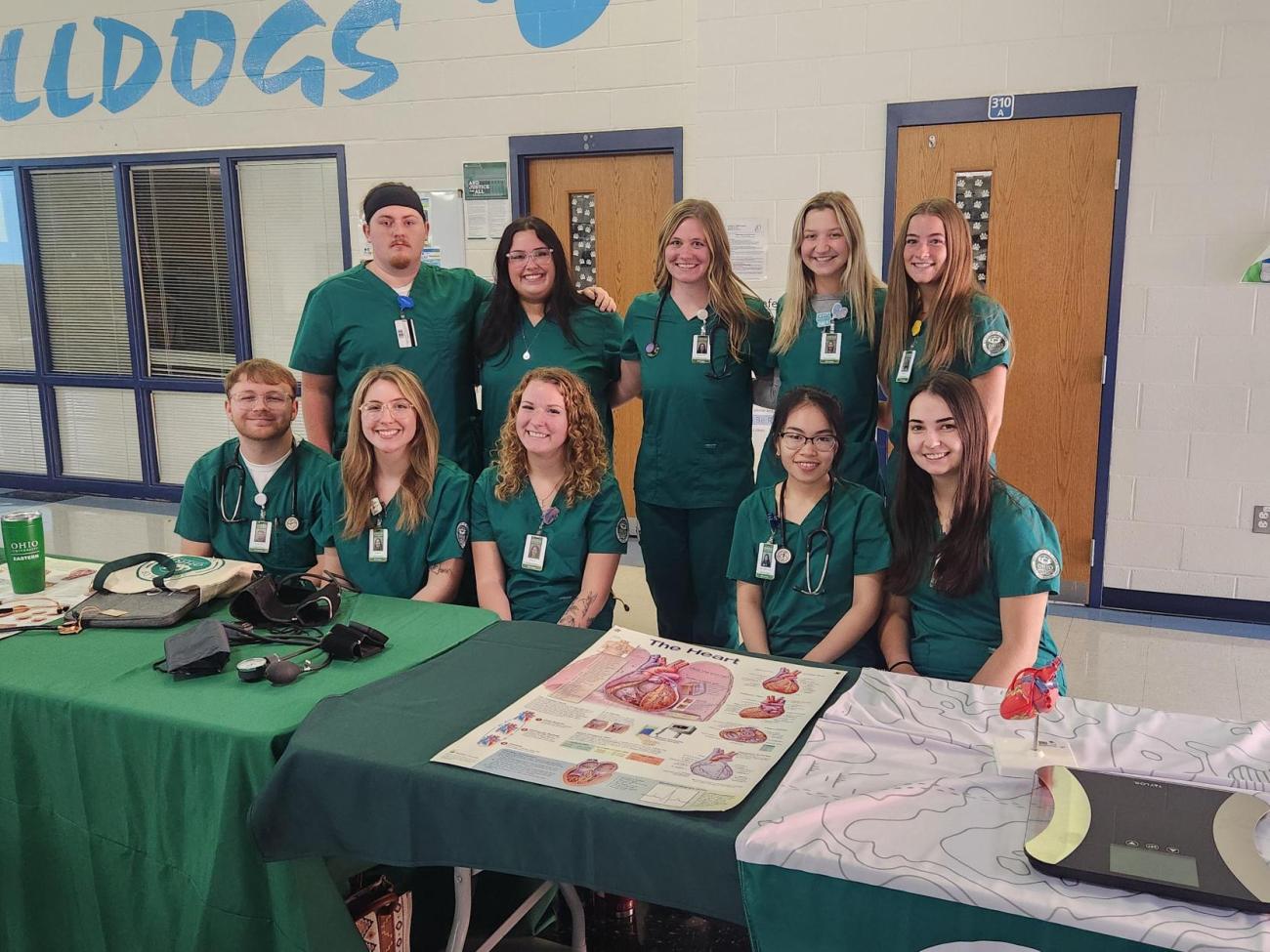 Nursing Students dressed in green scrubs at a local school health fair