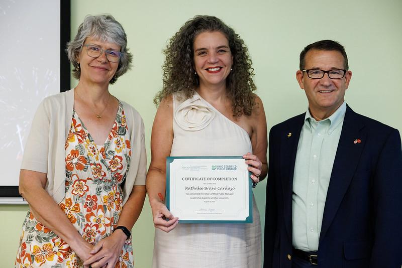 Nathalie Bravo Cardozo with Deanna Clifford and Jay Johnson. Nathalie Bravo Cardozo holds her certificate