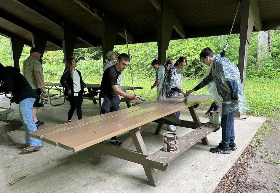 A group of students work on projects at tables inside a shelterhouse at the Wayne National Forest
