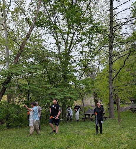 A group of students walk through grass at the Wayne National Forest