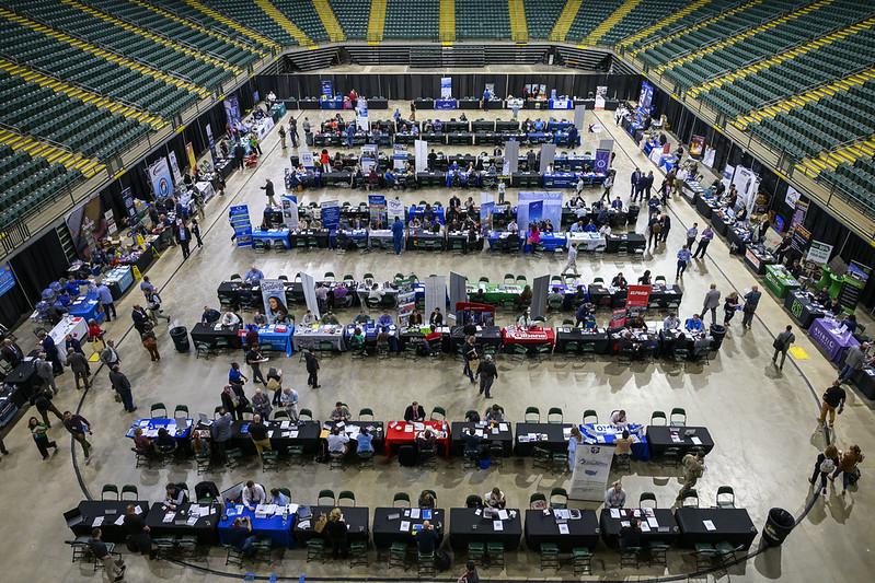 An overhead image the arena floor filled with tables and with people talking with one another at the Ohio Business Matchmaker event