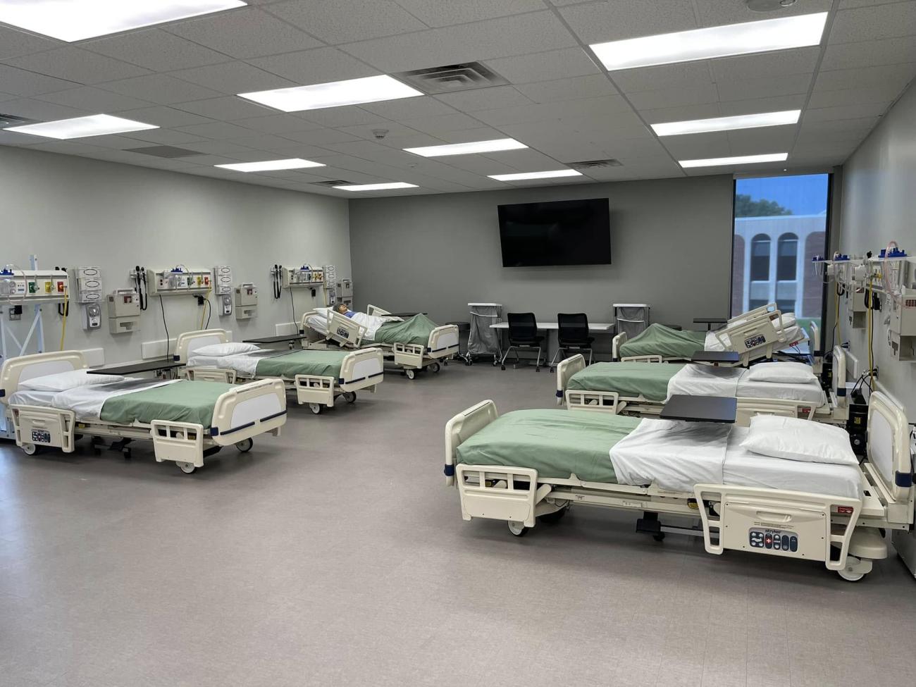 Multiple hospital beds are shown in the nursing lab at OHIO Lancaster