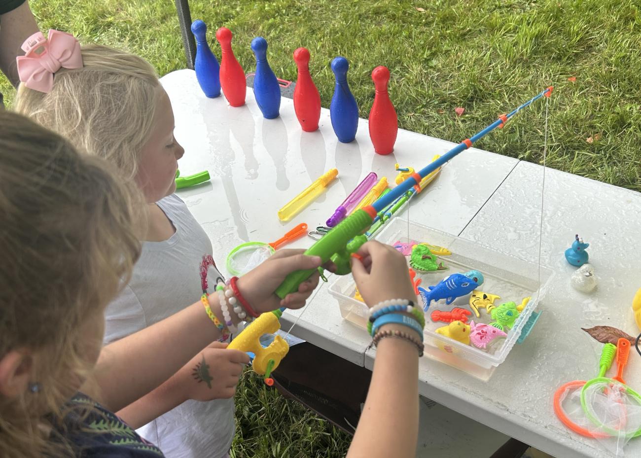 Two children playing a fishing game.