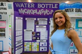 Allison Payton is shown standing in front of her project at Science Day