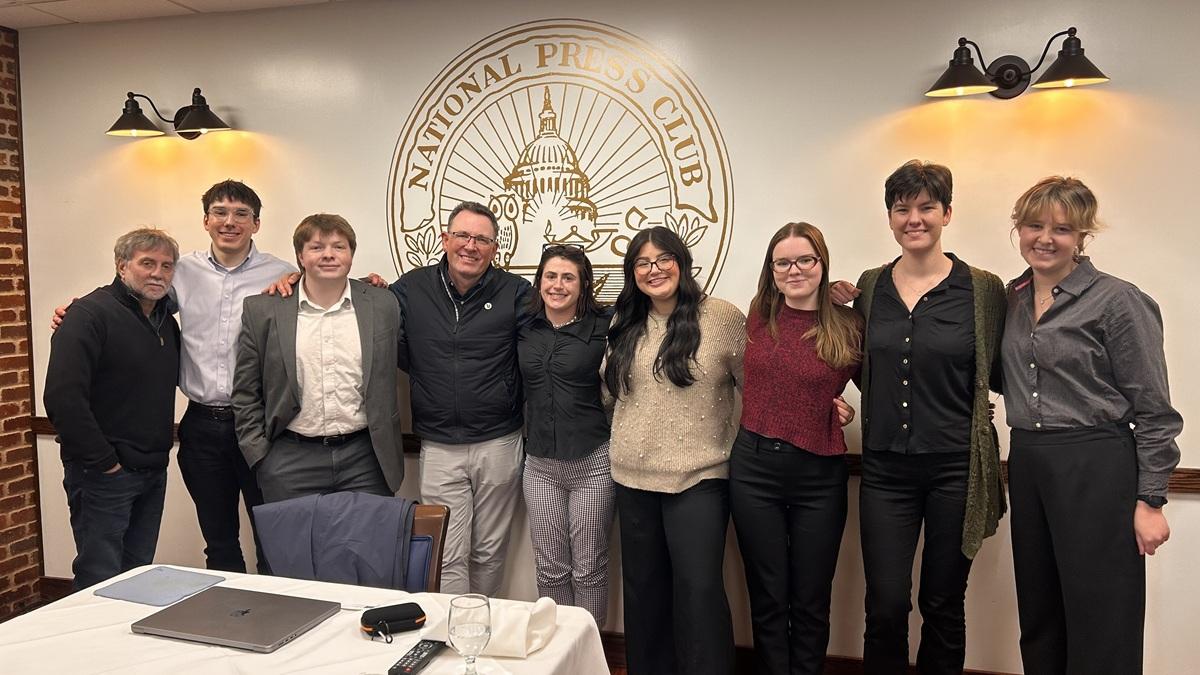 Katie Raines stands with interns and leaders while at the National Press Club