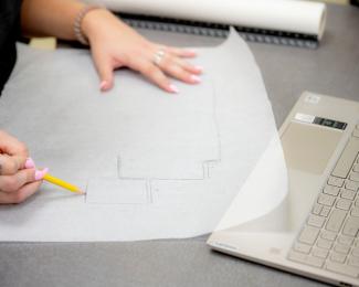 A student drawing a blueprint