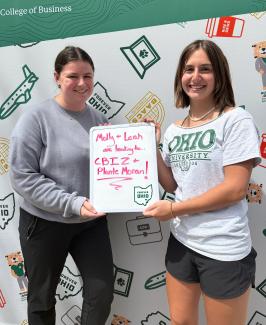 OHIO COB students Molly and Leah holding a sign that says they are going to CBIZ & Plante Moran
