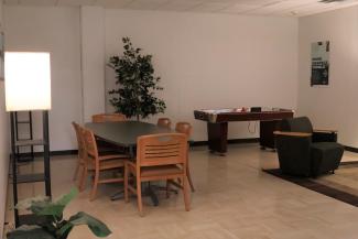 Ohio University Eastern Rufus Room - Interior room with conference table, air hockey table, plants and comfortable chair