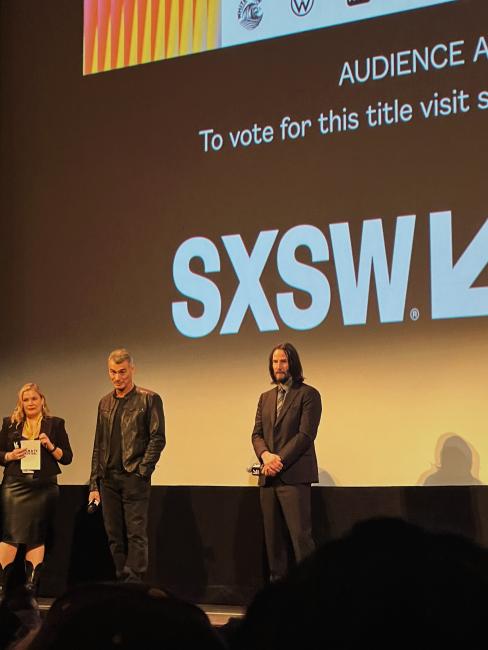 Keanu Reeves is shown speaking at a South By Southwest event