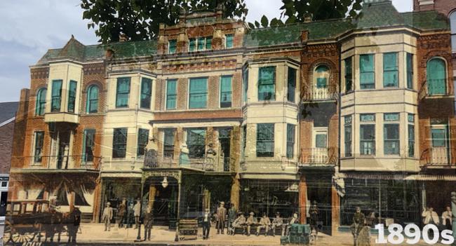 a historical photo of the former Hotel Berry, a three-story brick building; several men in period clothing sit and stand in front of the building, and a horse-drawn carriage can be seen in the street