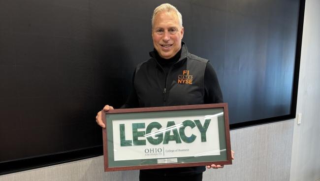 Tony Marino holds the Legacy Award