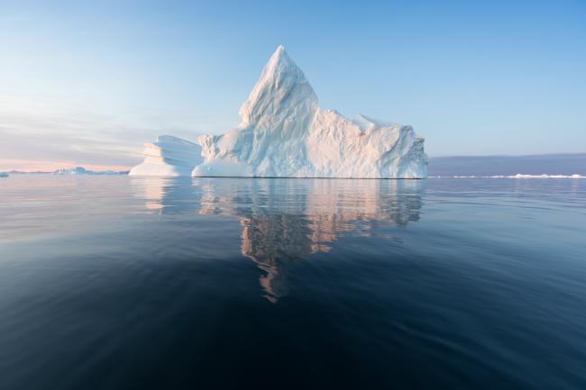 Antarctic iceberg reflected in still seawater 