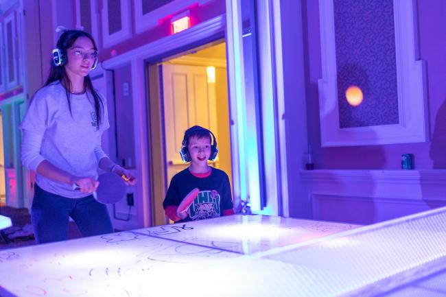 An OHIO student plays ping pong with a sibling during the GLOHIO event in Baker University Center