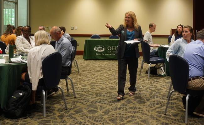 Dr. Haley Duschinski walks among the crowd and leads a presentation