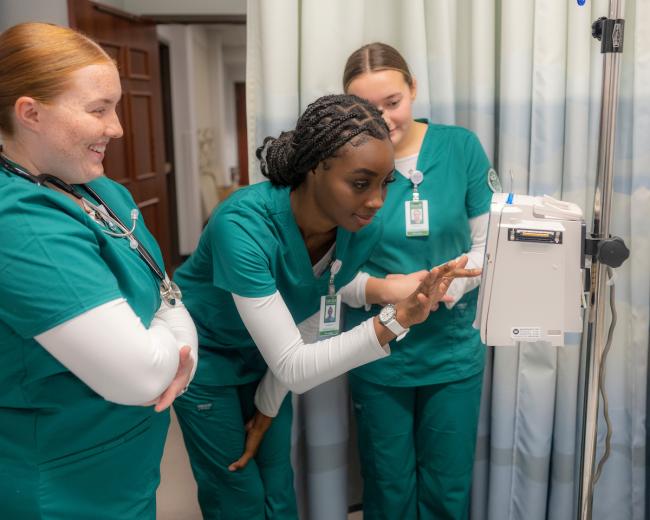 Three OHIO students work on equipment in a nursing lab on OHIO's Athens Campus