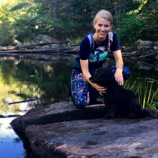 Sarah Welch on a rock in a pond