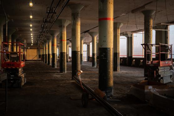  A view of a floor with high pillars and construction equipment around