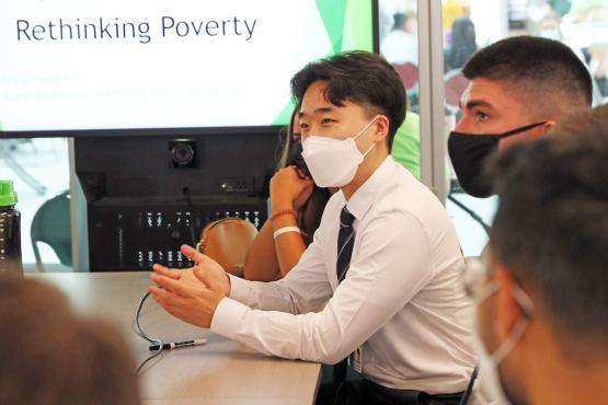 Students in workshop participating in a facilitated discussion about poverty