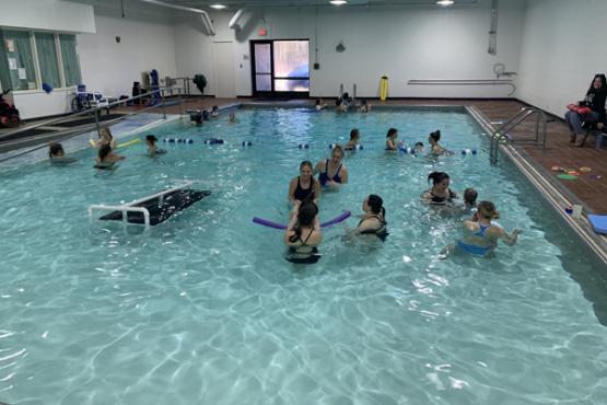  Instructors work with children in the pool at Beacon School.&quot; loading=&quot;lazy 